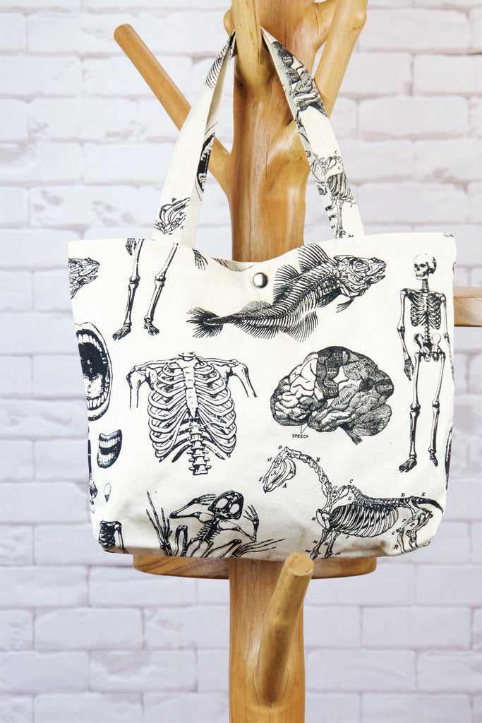 Handbag | Biology Skeletons - anatomy, anatomy print, bag, biology, handbag, human skeleton, nature, Shopper, skeleton, small, snap button, tools, Tote, tote bag - Wander Emporium